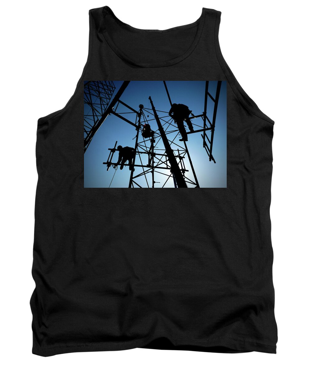 Tower Steel Climbing Safety Rescue Blue Silhouette Sun Crane Boom Communications Cell Cellular Antenna Beacon Black Workers Cellphones Fall Protection Osha Rigging Heights Tower Technician Rope Work Ropes Aerial High Harness Tank Top featuring the photograph Tower Tech by Bob Geary