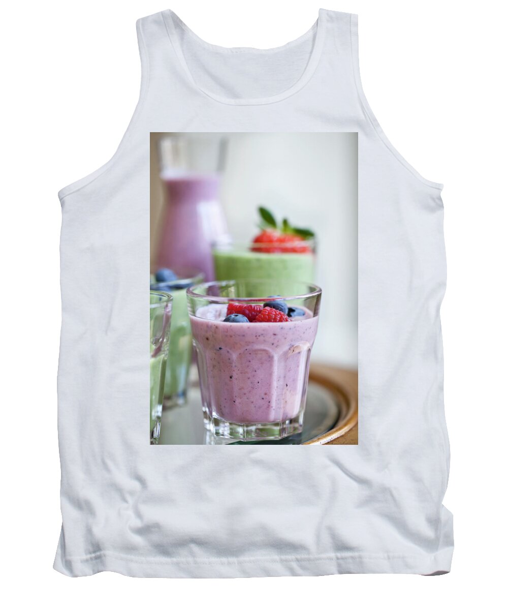 Ip_12593310 Tank Top featuring the photograph Berry Smoothies And Green Smoothies In Various Cups And Carafes, Topped With Fruit #1 by Ryla Campbell
