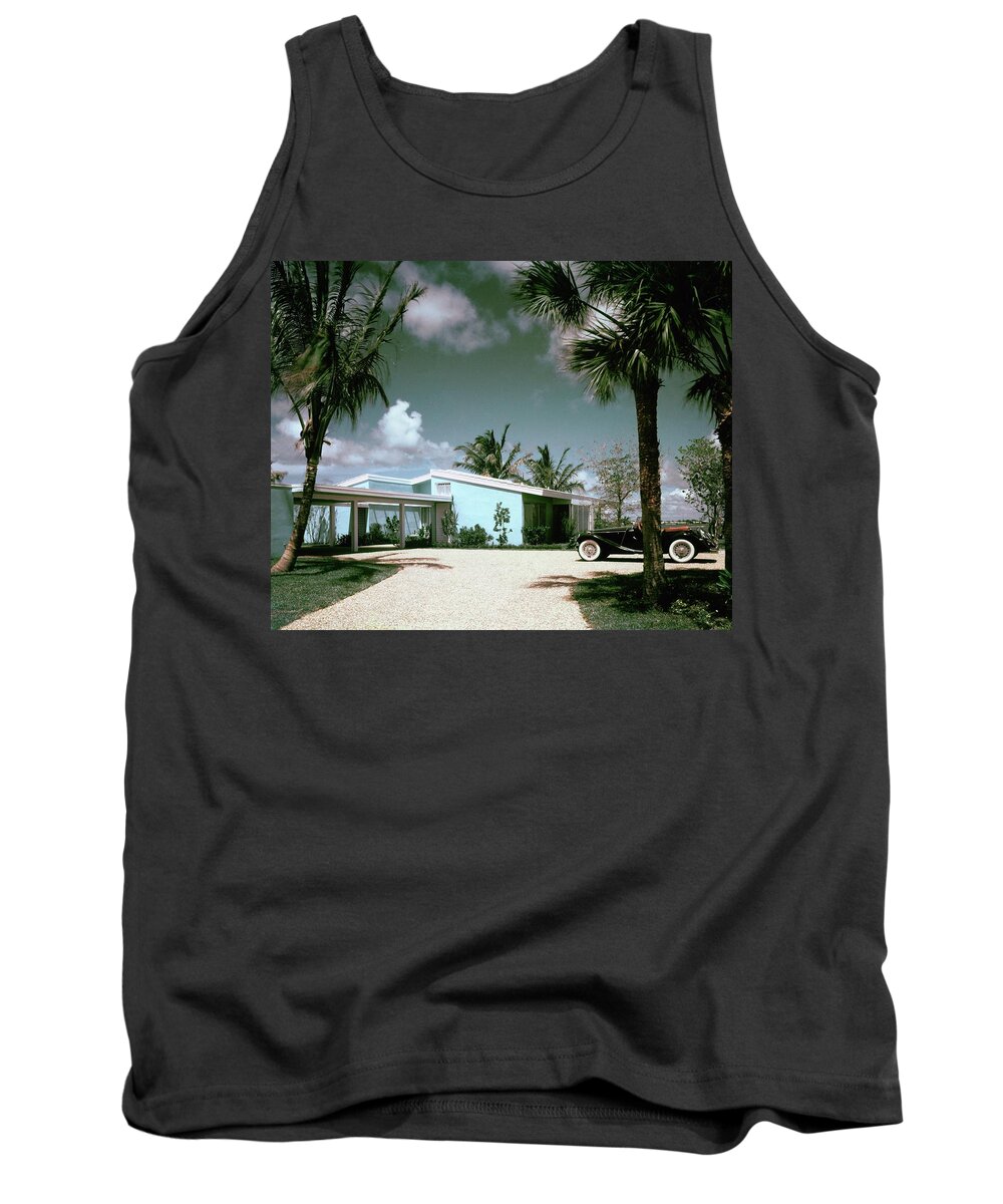 Nobodyoutdoorsdaytimehousedwellingdrivewayretroold-fashionedvintagevintage Cartransportationcarmotor Vehicleautomobilevehicletreemiamimiami-dade Countyfloridausanorth Americasouthern United Statesnorth American Atlantic Coastrobert M. Littlearchitecture #condenasthouse&gardenphotograph November 1st 1955 Tank Top featuring the photograph A Vintage Car Parked Outside A Blue House by Tom Leonard