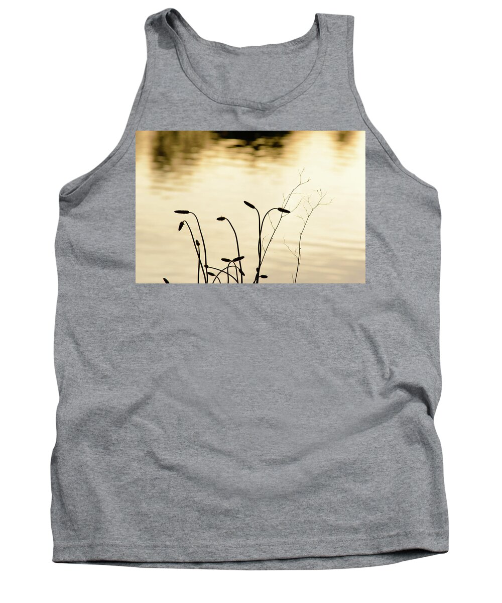 Bank Tank Top featuring the photograph Silhouetted plants at the side of a lake at sunset by Johan Ferret