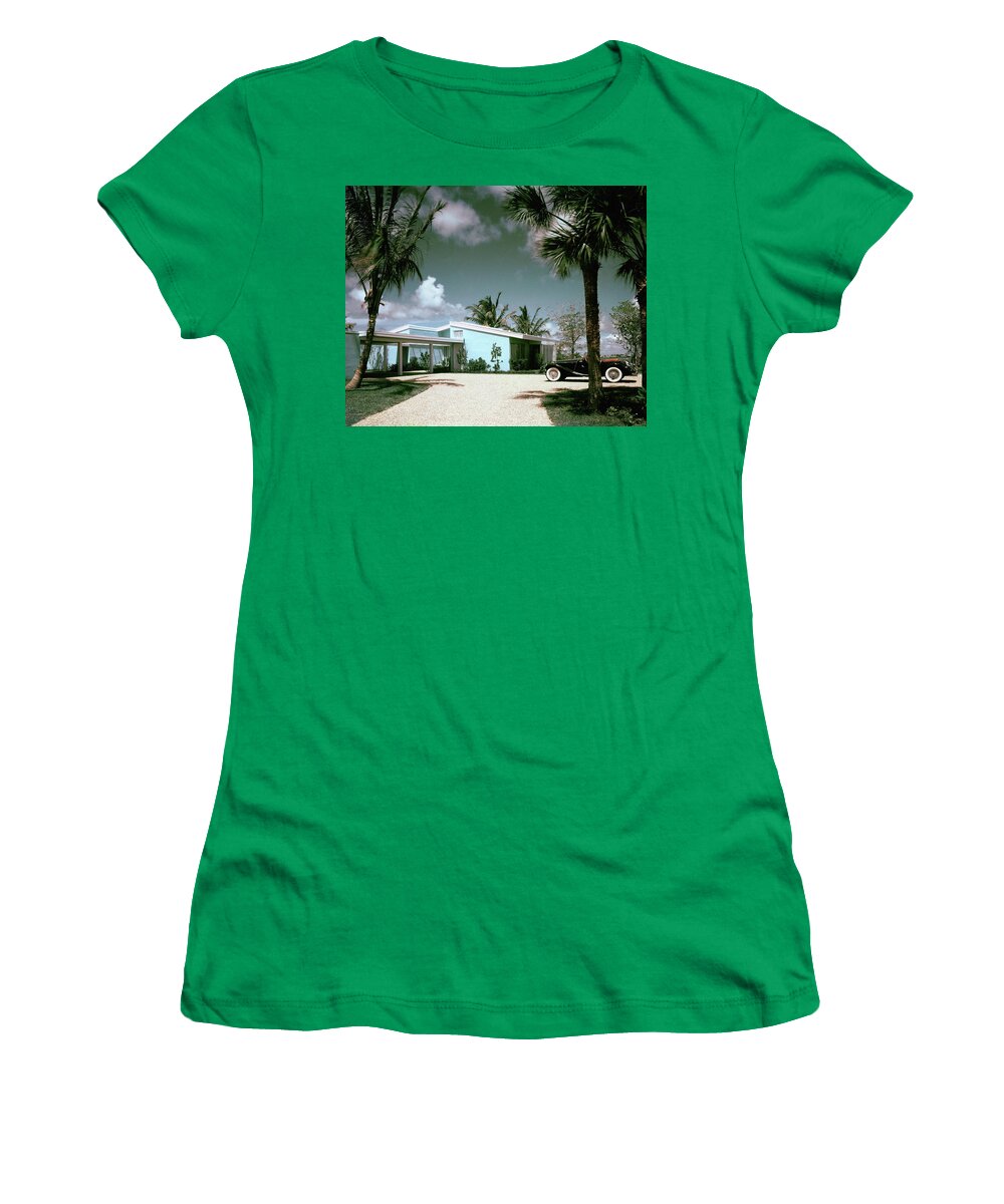 Nobodyoutdoorsdaytimehousedwellingdrivewayretroold-fashionedvintagevintage Cartransportationcarmotor Vehicleautomobilevehicletreemiamimiami-dade Countyfloridausanorth Americasouthern United Statesnorth American Atlantic Coastrobert M. Littlearchitecture #condenasthouse&gardenphotograph November 1st 1955 Women's T-Shirt featuring the photograph A Vintage Car Parked Outside A Blue House by Tom Leonard