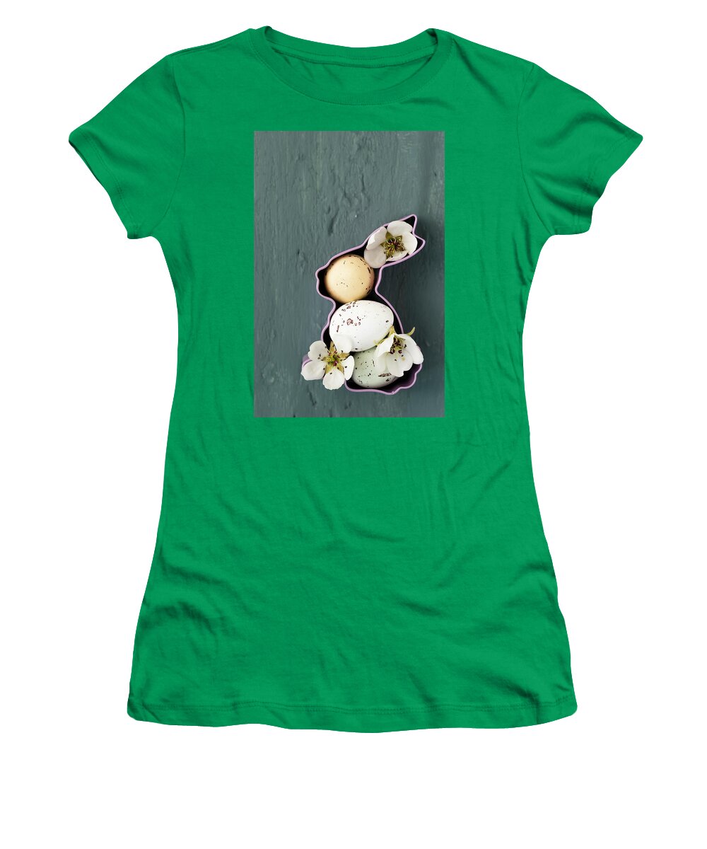 Ip_11374940 Women's T-Shirt featuring the photograph Sugar-coated Chocolate Eggs And Pear Blossom In Bunny-shaped Pastry Cutter by Mandy Reschke