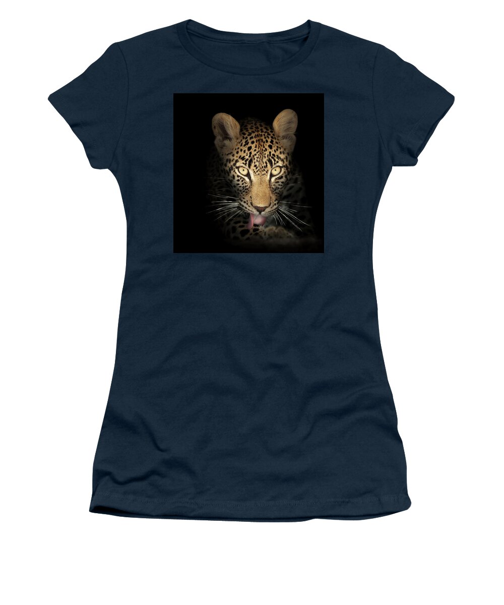 Leopardeyesdarkblackbackgroundwildlifeanimalmammalwildcatpantherapardusspottedfierceintensestarelookpowerfulpredatorcloseupclose-upclosepiercinglicktonguefrontviewafricaphotographonenobodyportraitsafaripawyellownaturedetail015092rs2 Women's T-Shirt featuring the photograph Leopard In The Dark by Johan Swanepoel