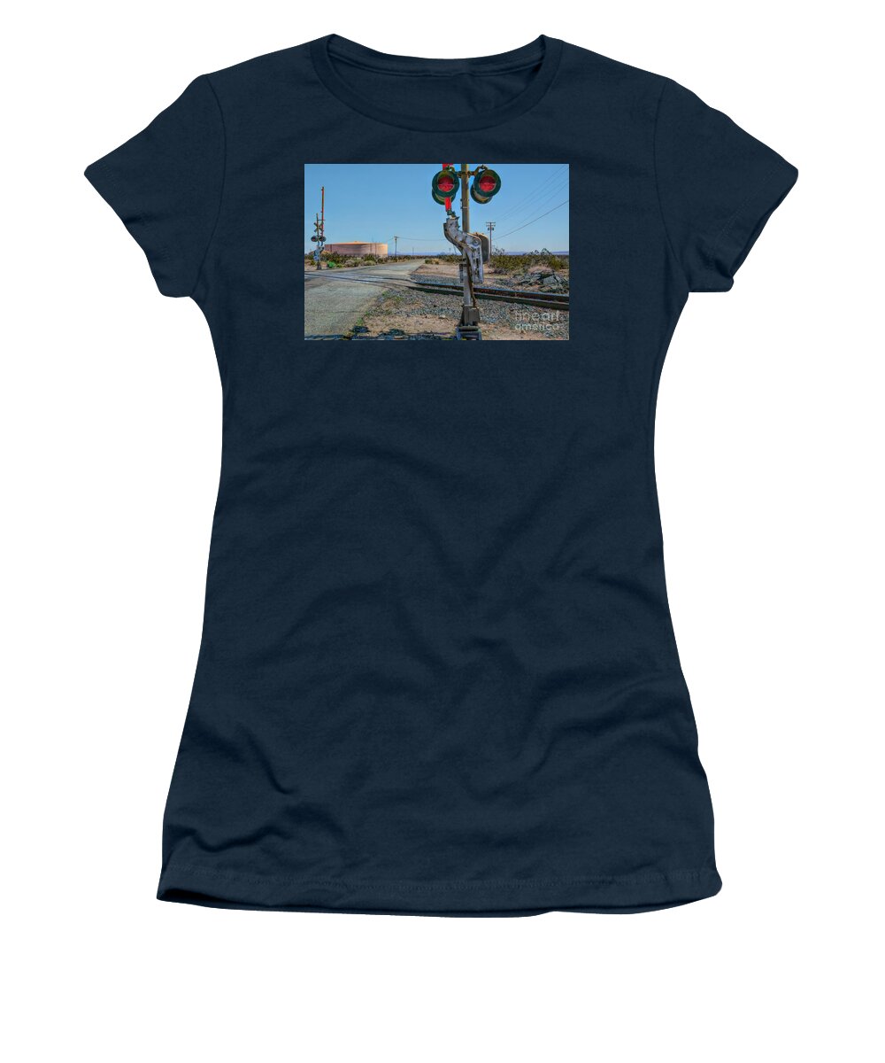 Railway Crossing; Railroad Crossing; Train Crossing; Union Pacific; Freight Train; Yellow; Blue; Green; Red; Water Storage; Train Tracks; Train Signal; Mojave Desert; Mohave Desert; Antelope Valley; Joe Lach; Women's T-Shirt featuring the photograph The Railway Crossing by Joe Lach