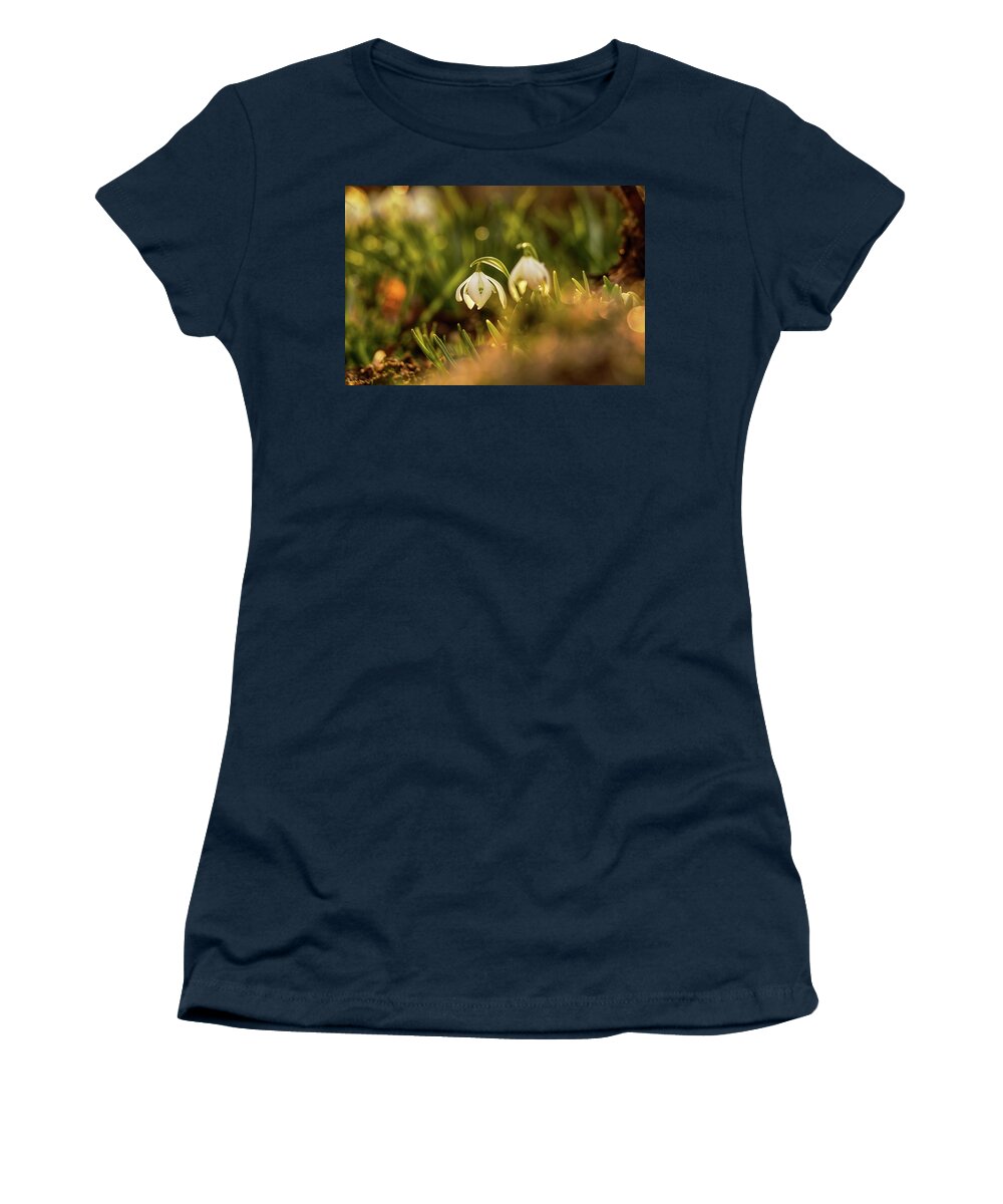 Galanthus Nivalis Women's T-Shirt featuring the photograph Morning light shining on easter flower on the garden. Galanthus nivalis grow up. Snowdrop shoot in morning. First spring flower. New start by Vaclav Sonnek