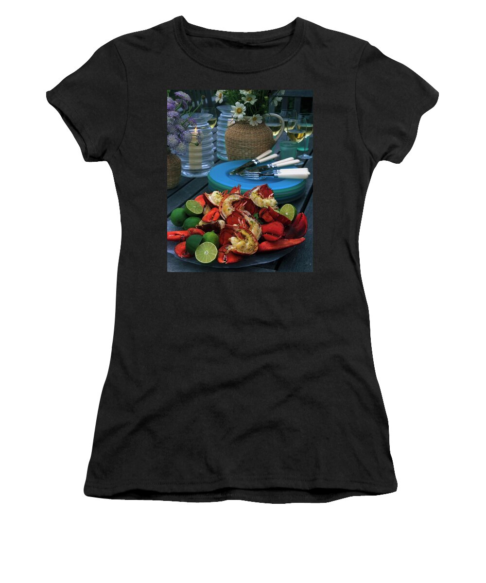 Still Life Women's T-Shirt featuring the photograph A Meal With Lobster And Limes by Romulo Yanes