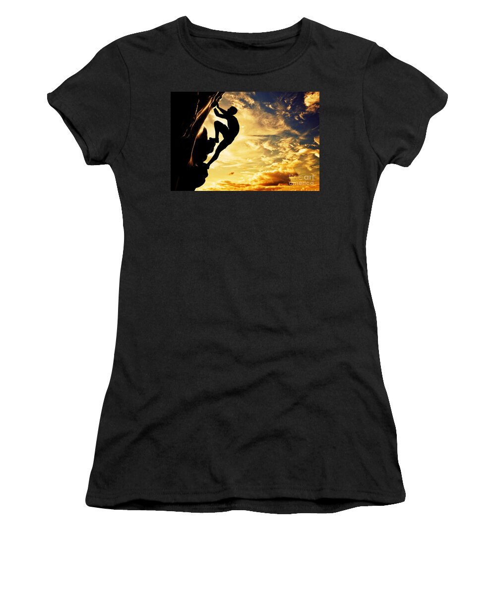 Climb Women's T-Shirt featuring the photograph A silhouette of man free climbing on rock mountain at sunset by Michal Bednarek