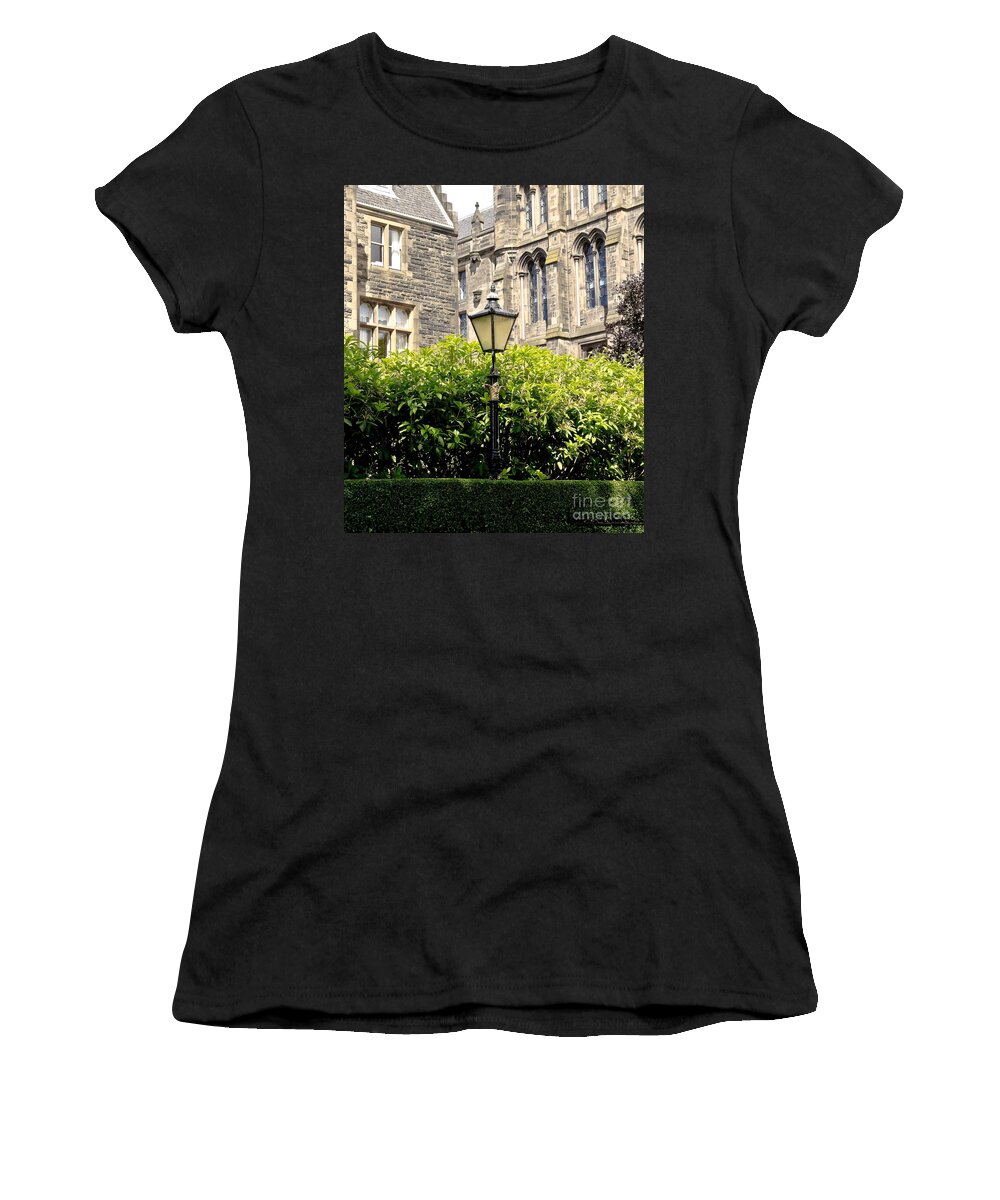 Lamppost Women's T-Shirt featuring the photograph Lamppost in front of green bushes and old walls. by Elena Perelman