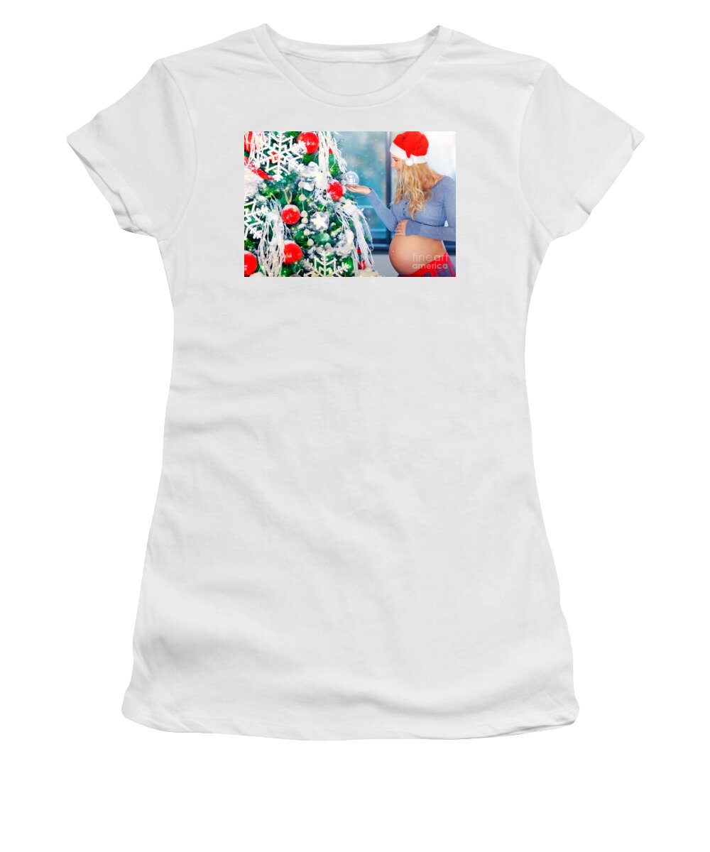 Abdomen Women's T-Shirt featuring the photograph Cute pregnant woman adorns Christmas tree by Anna Om