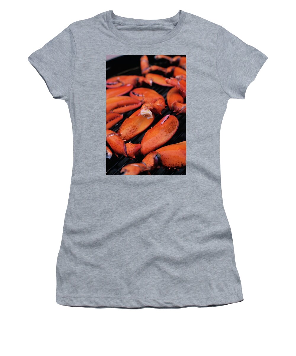 Cooking Women's T-Shirt featuring the photograph A Group Of Lobster Claws On A Grill by Romulo Yanes