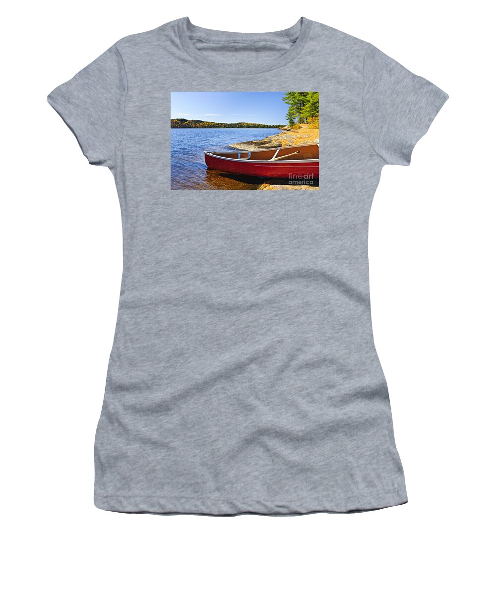Canoe Women's T-Shirt featuring the photograph Red canoe on shore by Elena Elisseeva