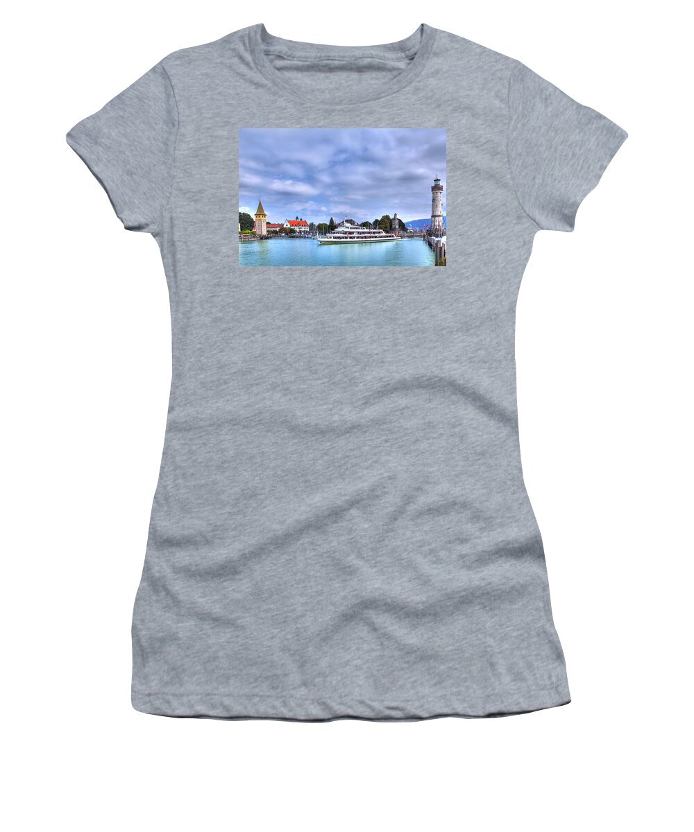 Adventure Women's T-Shirt featuring the photograph a ship drives in the harbour of Lindau at the Lake Constance by Gina Koch