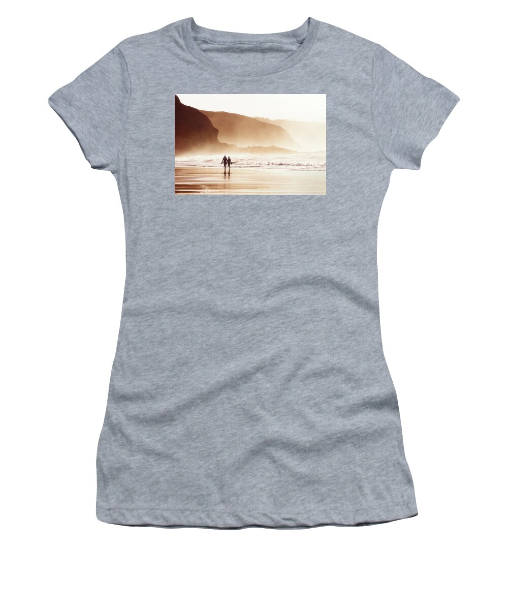 Couple Women's T-Shirt featuring the photograph Couple Walking On Beach With Fog by Mikel Martinez de Osaba
