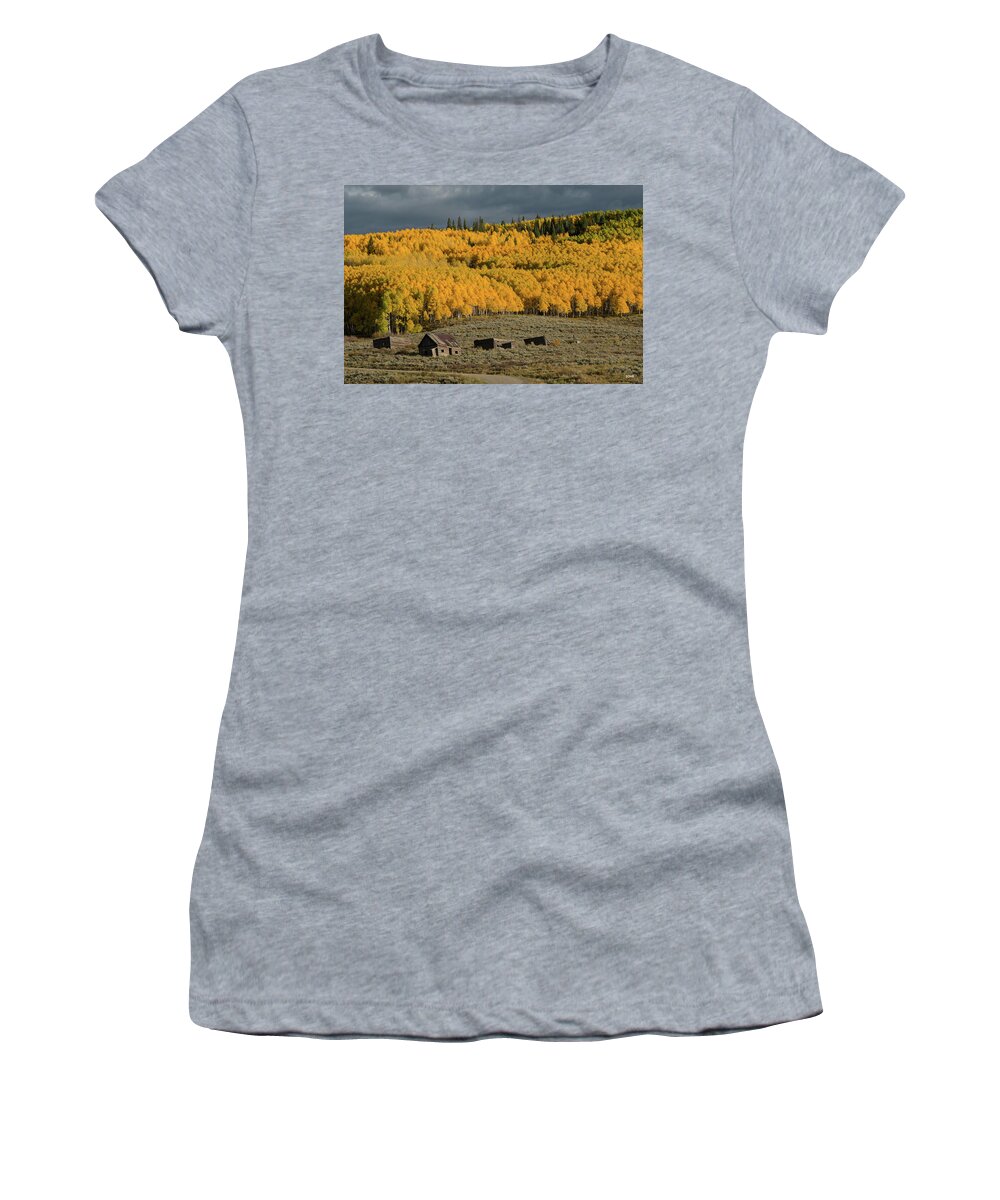 A Blazing Hillside Of Aspen Trees Seems To Stand Guard Above A Collection Of Abandoned Ranch Buildings.  Women's T-Shirt featuring the photograph Hills Afire by Dana Sohr