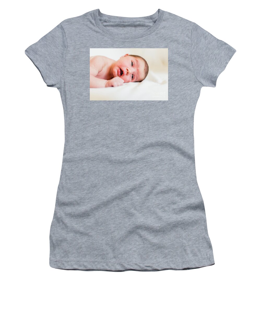 Baby Women's T-Shirt featuring the photograph Portrait of newborn baby girl feels safe and awake to a new life. by Joaquin Corbalan