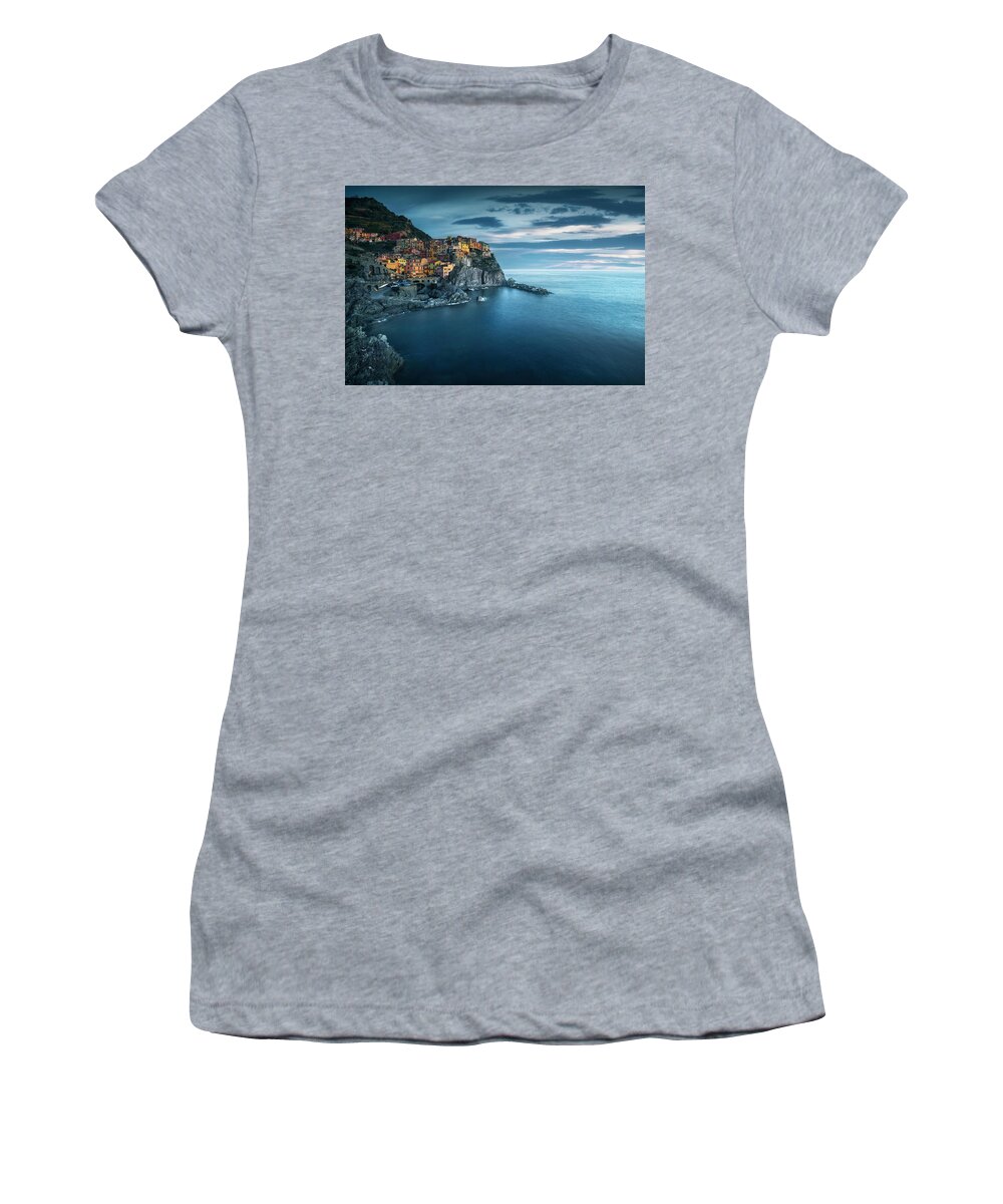Manarola Women's T-Shirt featuring the photograph Manarola village, rocks and sea in blue hour. Cinque Terre, Ital by Stefano Orazzini