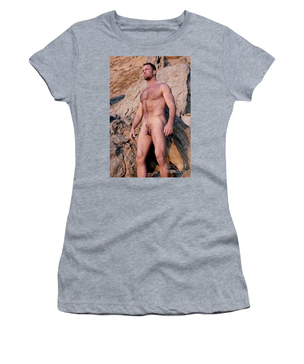 Nude Women's T-Shirt featuring the photograph Naked man with muscles and a hairy body stands in front of rocks. by Gunther Allen