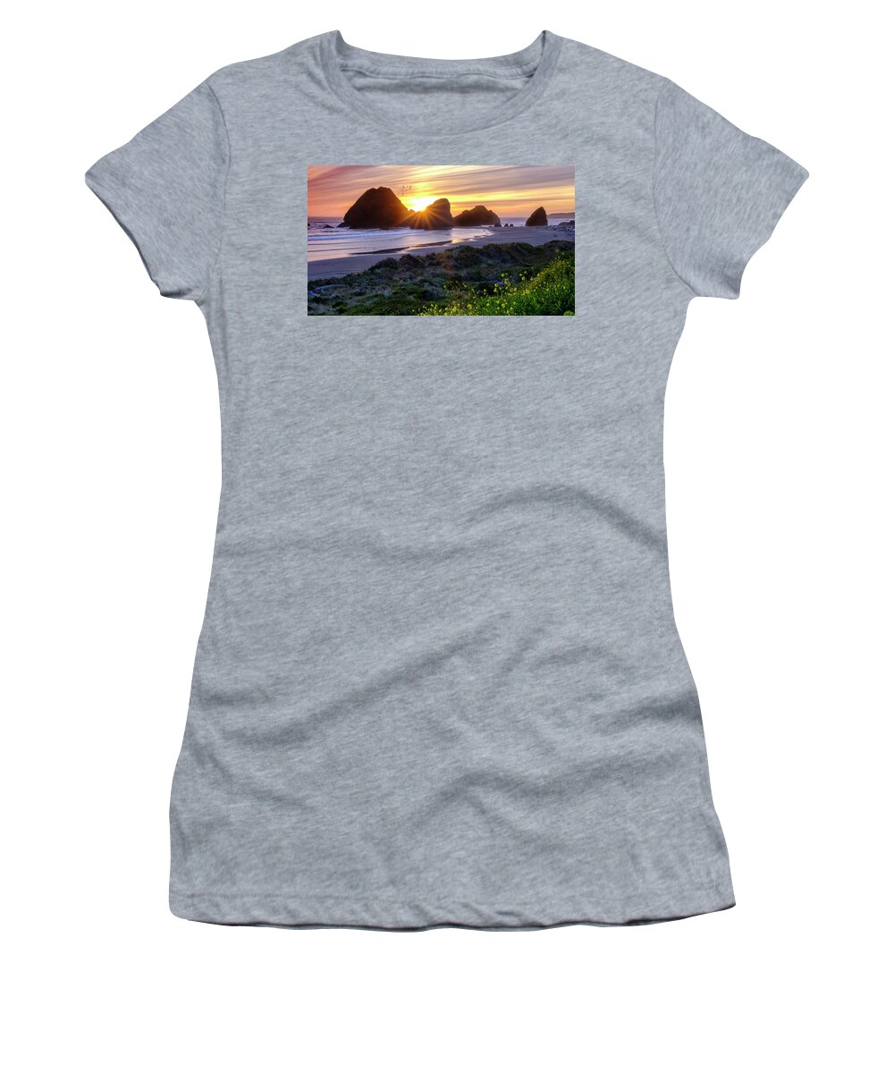Sunset Women's T-Shirt featuring the photograph Oregon Coastline Sunset Behind A Large Rock Formations by Tony Locke