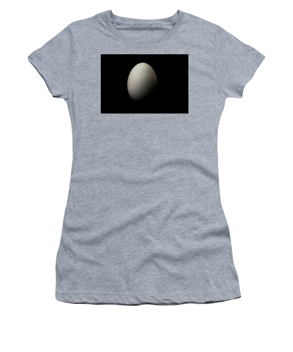 Egg Women's T-Shirt featuring the photograph White egg on black background still life by Alessandra RC