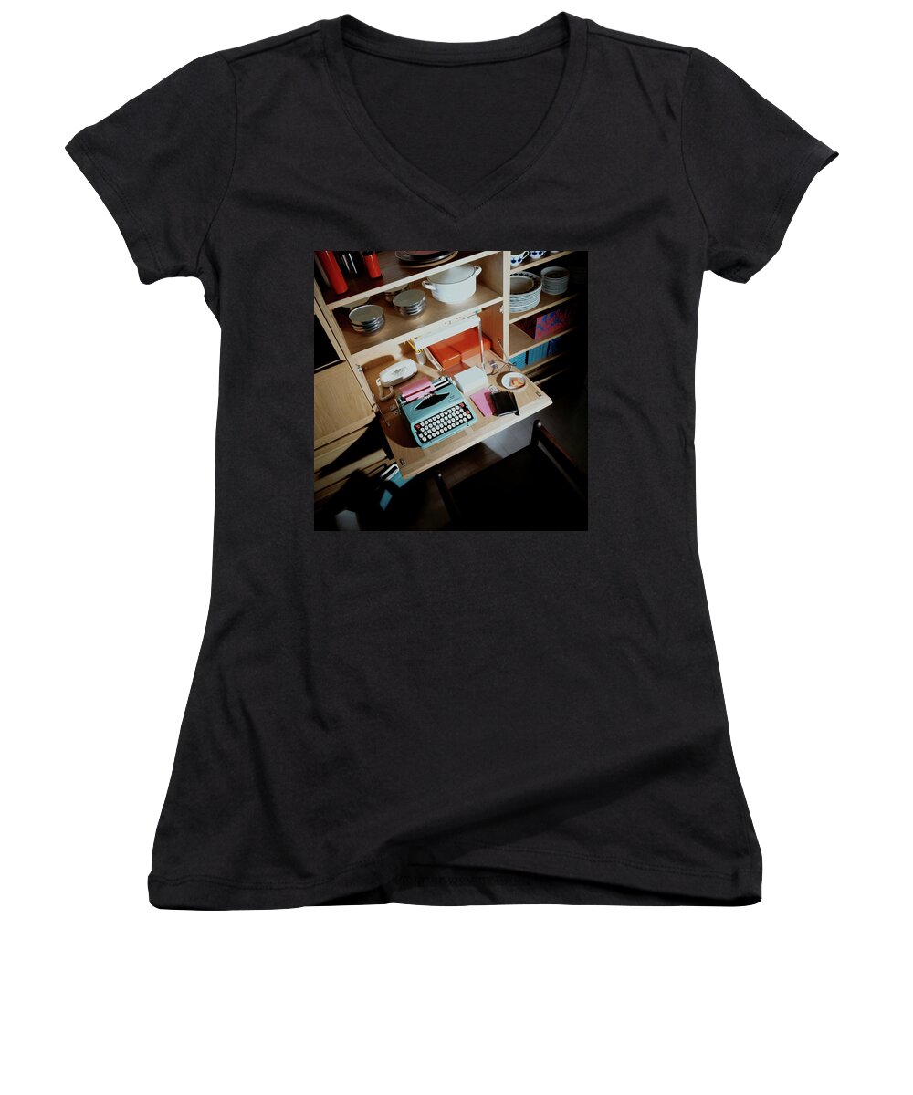 Indoors Women's V-Neck featuring the photograph A Cupboard With A Blue Typewriter by Ernst Beadle