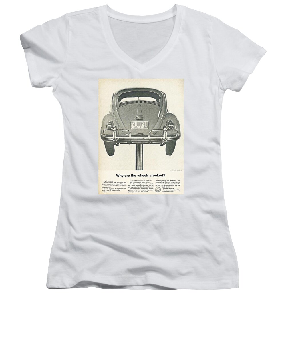 Vw Beetle Women's V-Neck featuring the digital art VW Beetle Advert 1962 - Why are the wheels crooked? by Georgia Clare