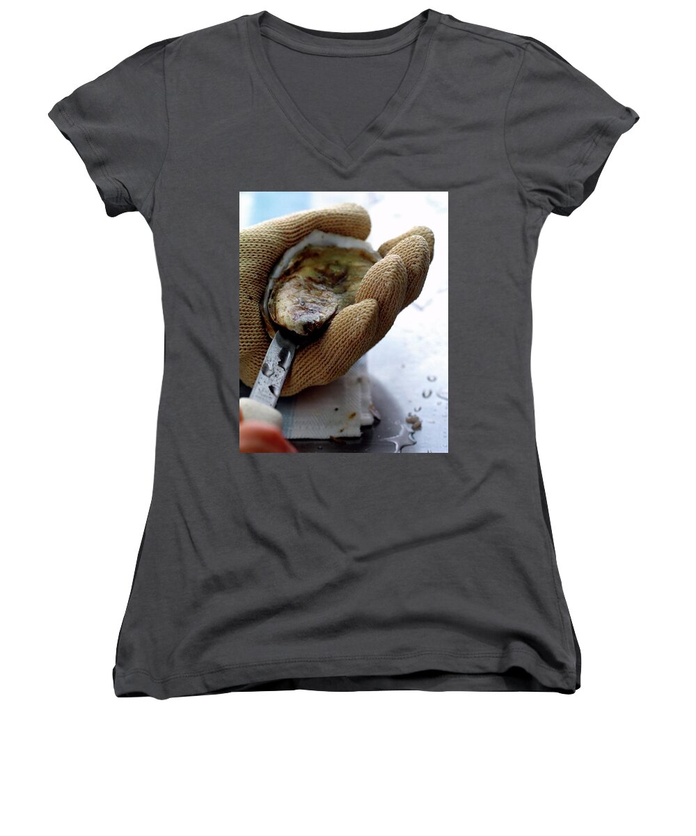 Cooking Women's V-Neck featuring the photograph An Oytser Being Shucked by Romulo Yanes
