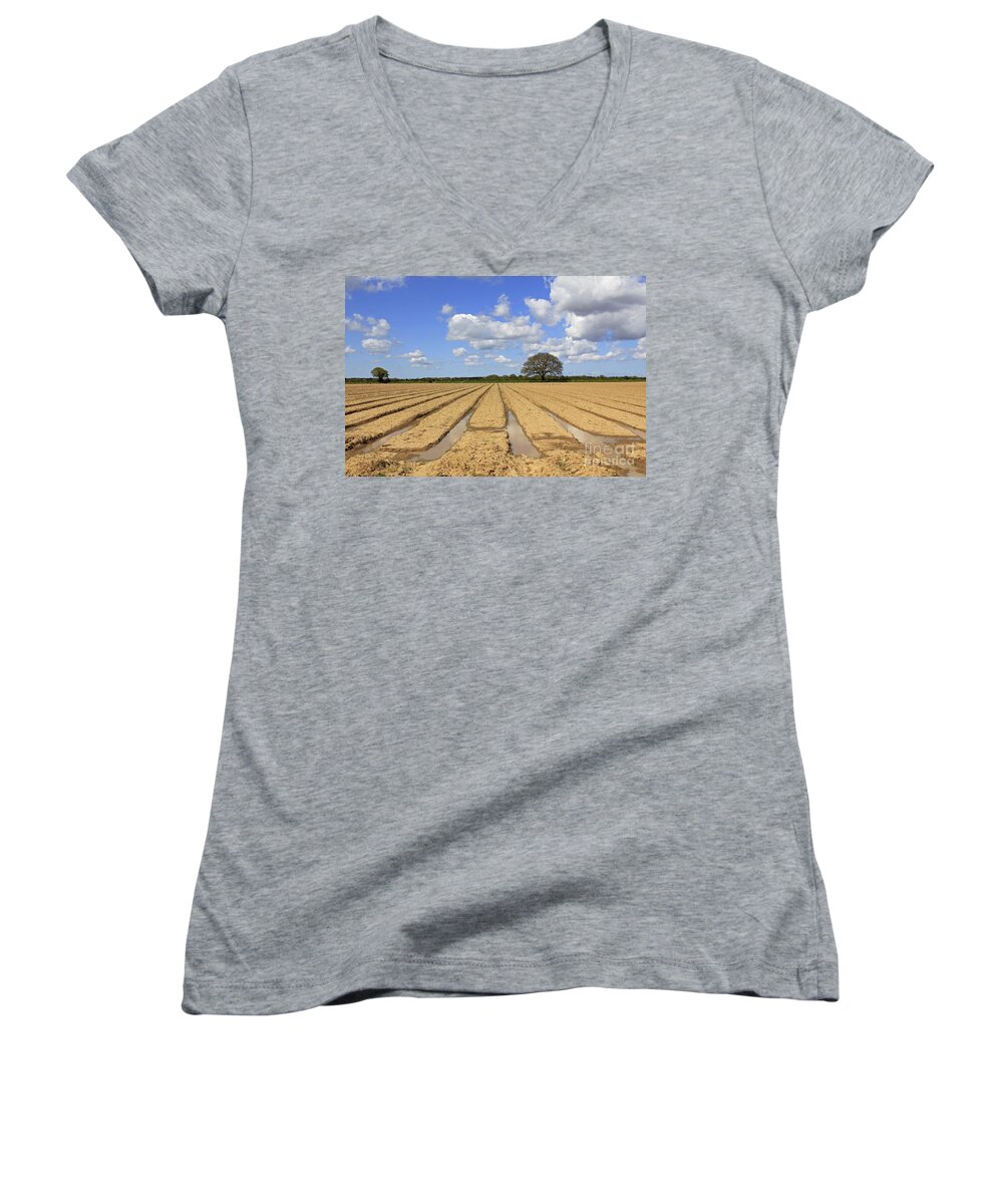 Ploughed Field Uk English British Landscape Countryside Furrow Tracks Converging Lines Earth Agriculture Farming Farmland Fertile Oak Fluffy Clouds Blue Sky Summer Women's V-Neck featuring the photograph Ploughed Field by Julia Gavin