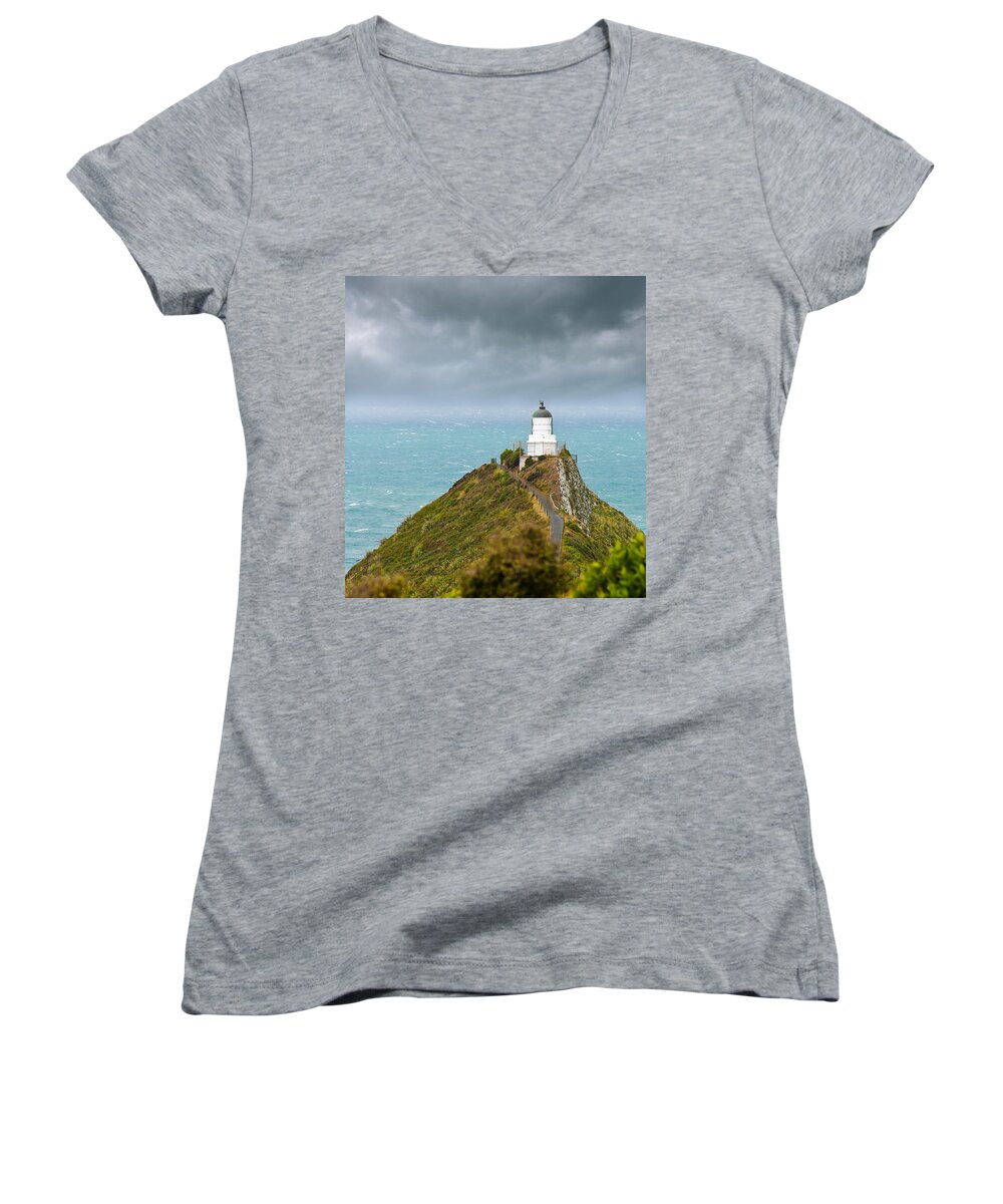 Beach Women's V-Neck featuring the photograph Nugget Point Light House and dark clouds in the sky #1 by U Schade