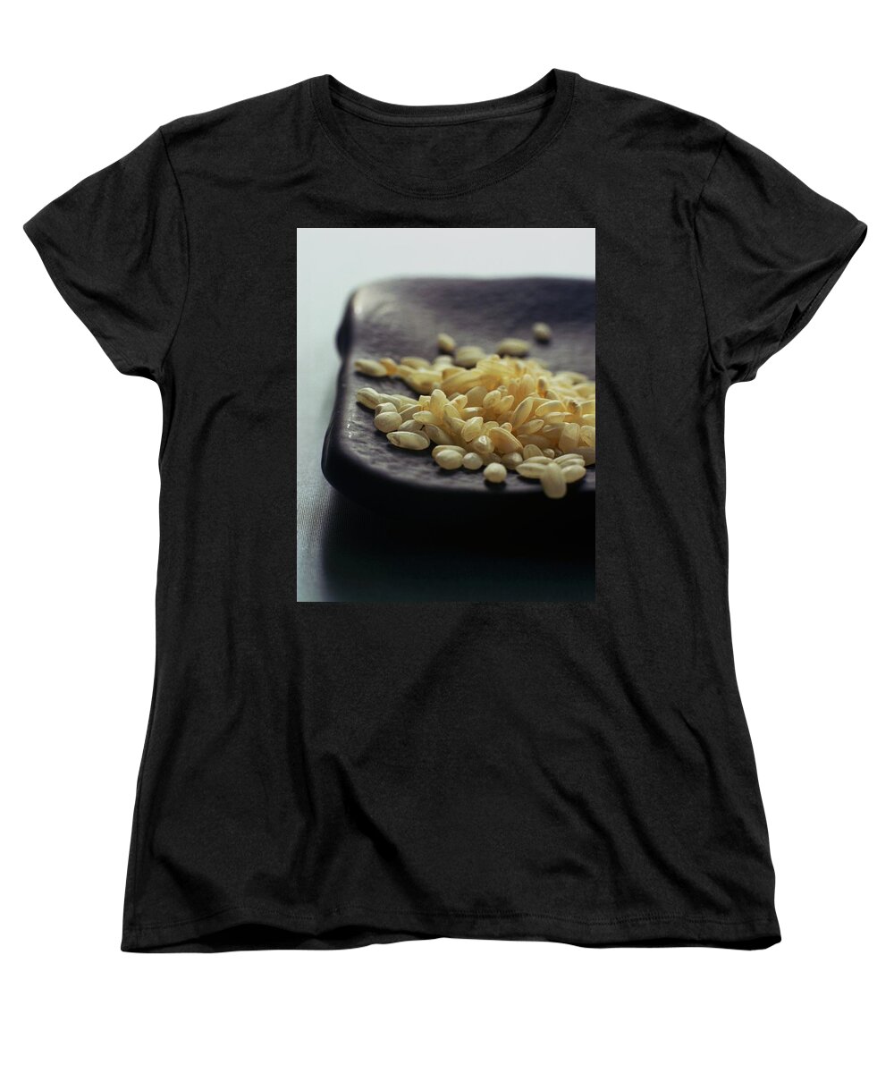 Grains Women's T-Shirt (Standard Fit) featuring the photograph Rice On A Black Plate by Romulo Yanes