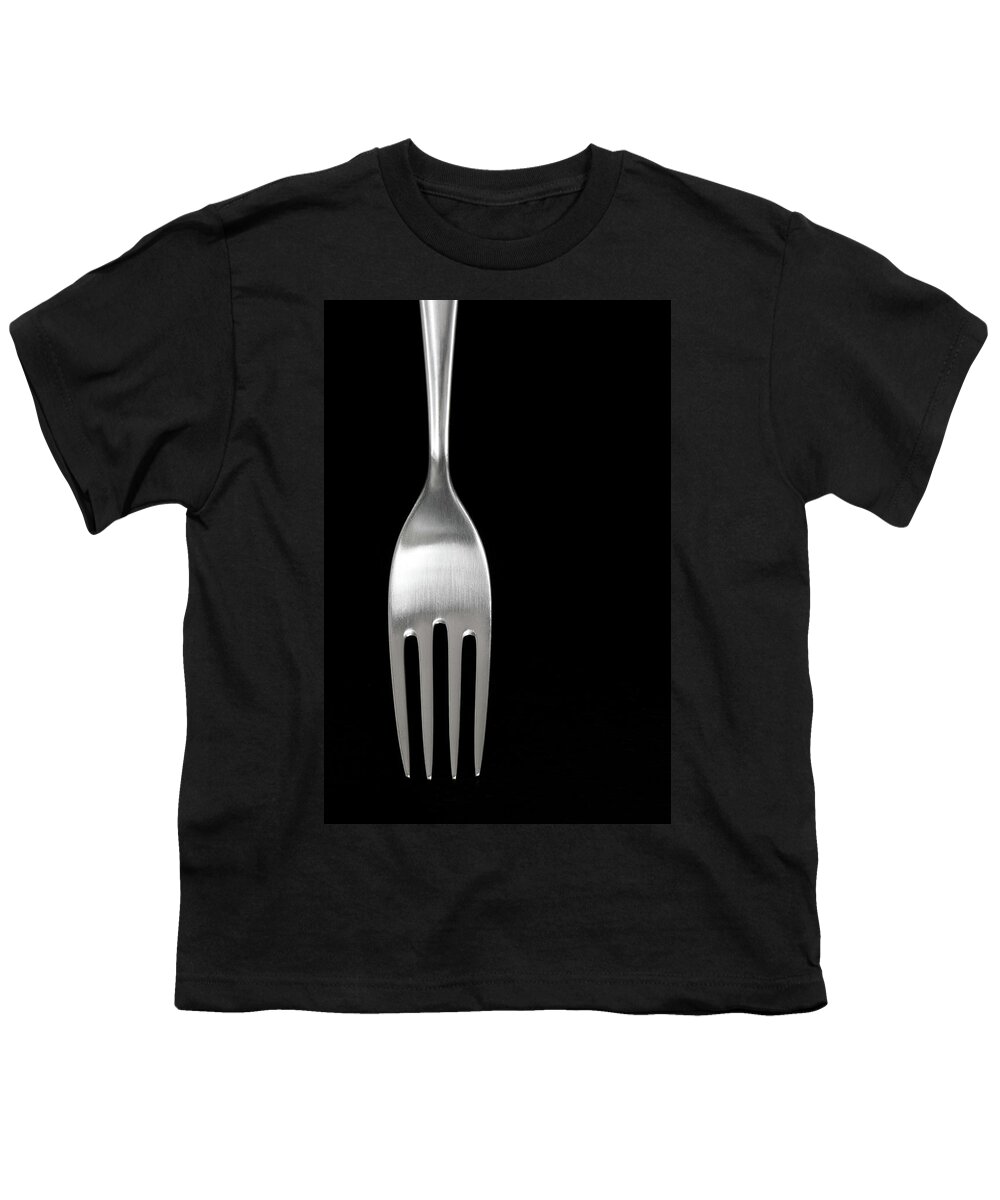 Fork Youth T-Shirt featuring the photograph Shiny silver fork on black background by GoodMood Art