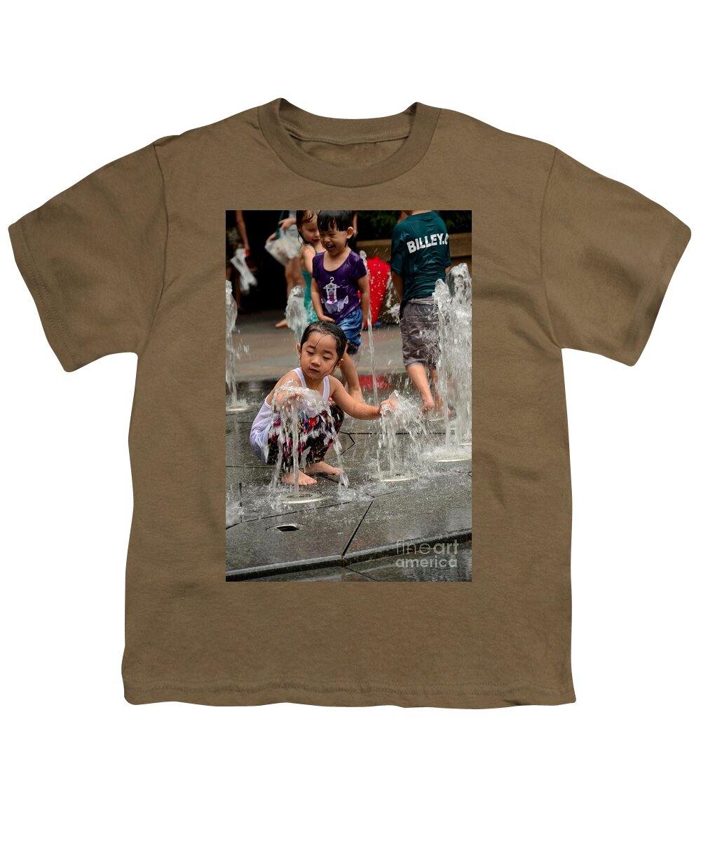 Girl Youth T-Shirt featuring the photograph Clothed children play at water fountain by Imran Ahmed