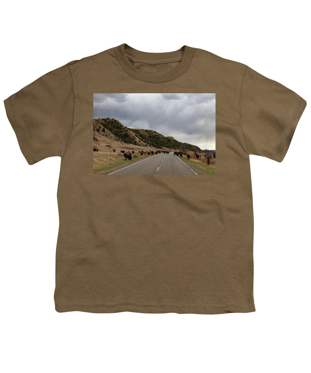 Buffalo Youth T-Shirt featuring the photograph Buffalo on the road at Theodore Roosevelt National Park in North Dakota #1 by Eldon McGraw