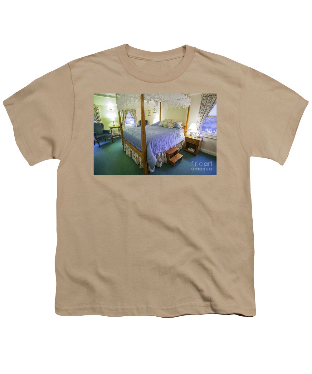 Apartment Youth T-Shirt featuring the photograph Fancy canopy bed in a cozy hotel bedroom. by Don Landwehrle