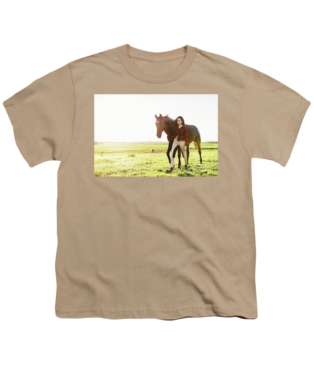 Woman Youth T-Shirt featuring the photograph Young woman standing next to her black horse by Michal Bednarek