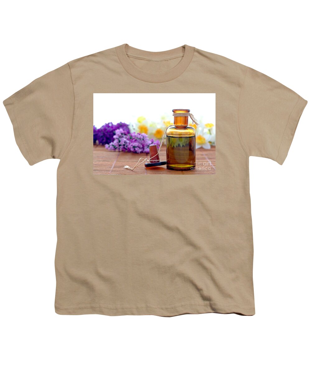Amber Youth T-Shirt featuring the photograph Aromatherapy Essential Oil Bottle with Flowers in a Spa by Olivier Le Queinec