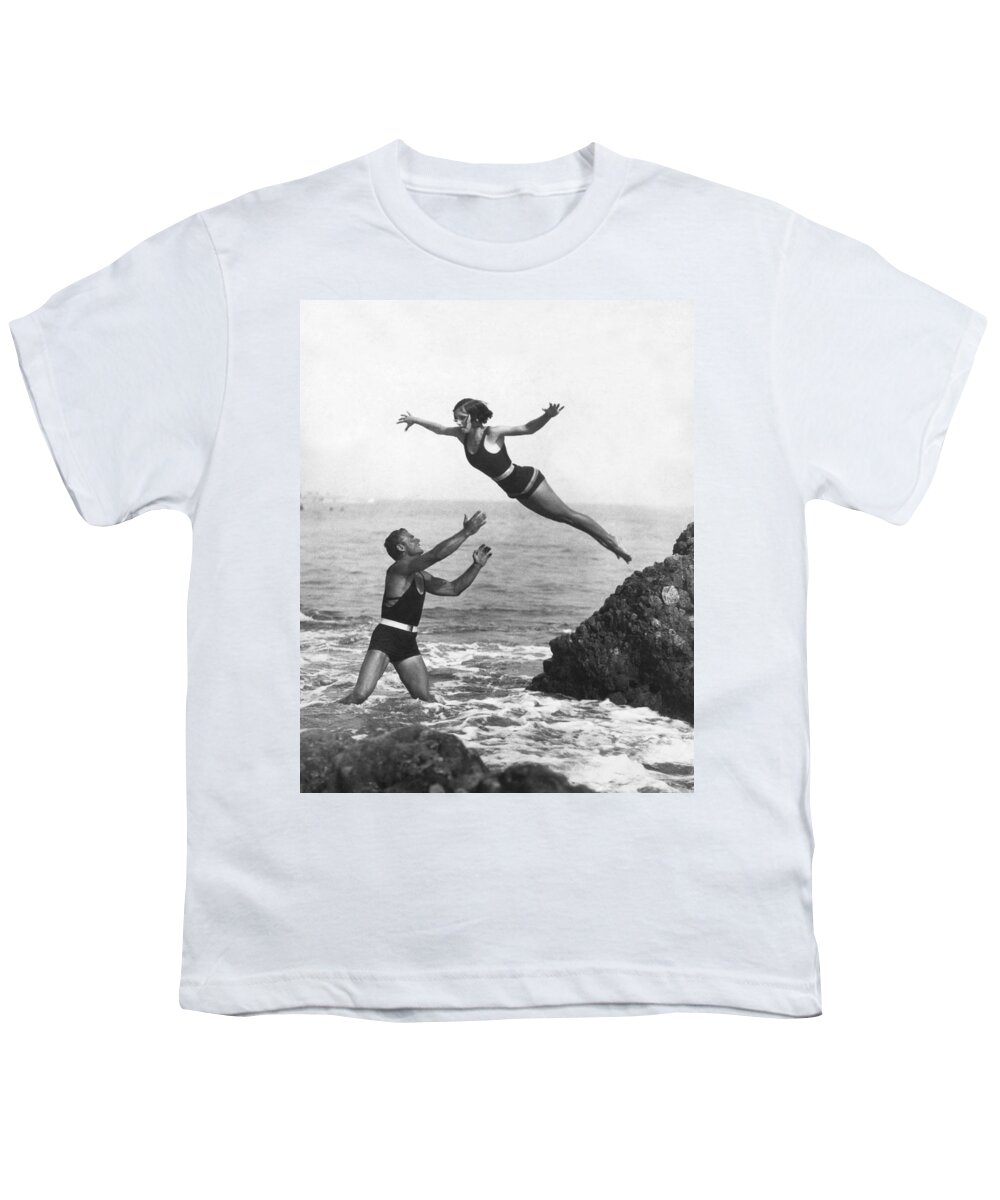 1920s Youth T-Shirt featuring the photograph Leap Into Life Guard's Arms by Underwood Archives