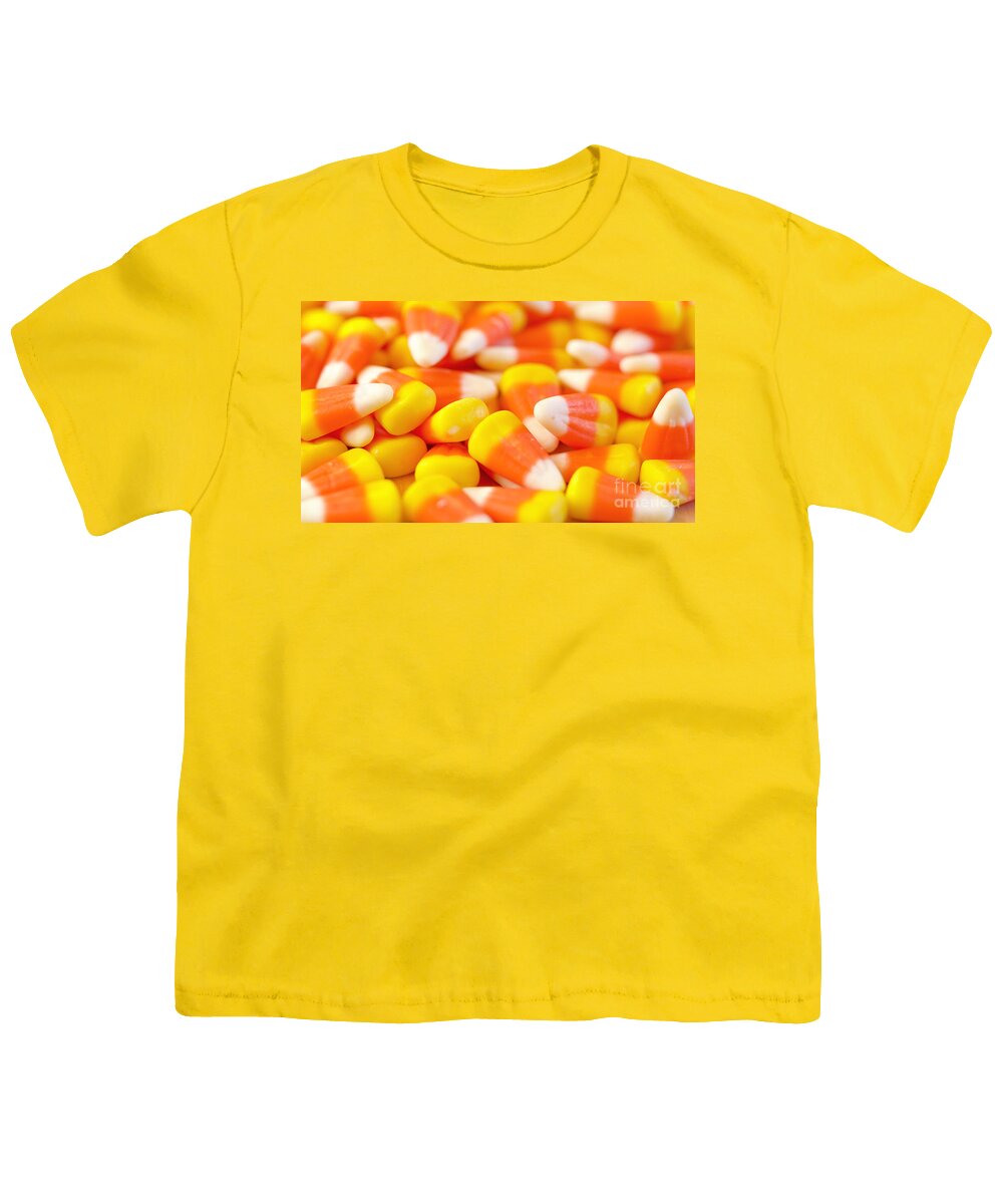 Halloween Youth T-Shirt featuring the photograph Macro closeup of Halloween traditional Candy Corn treats. by Milleflore Images