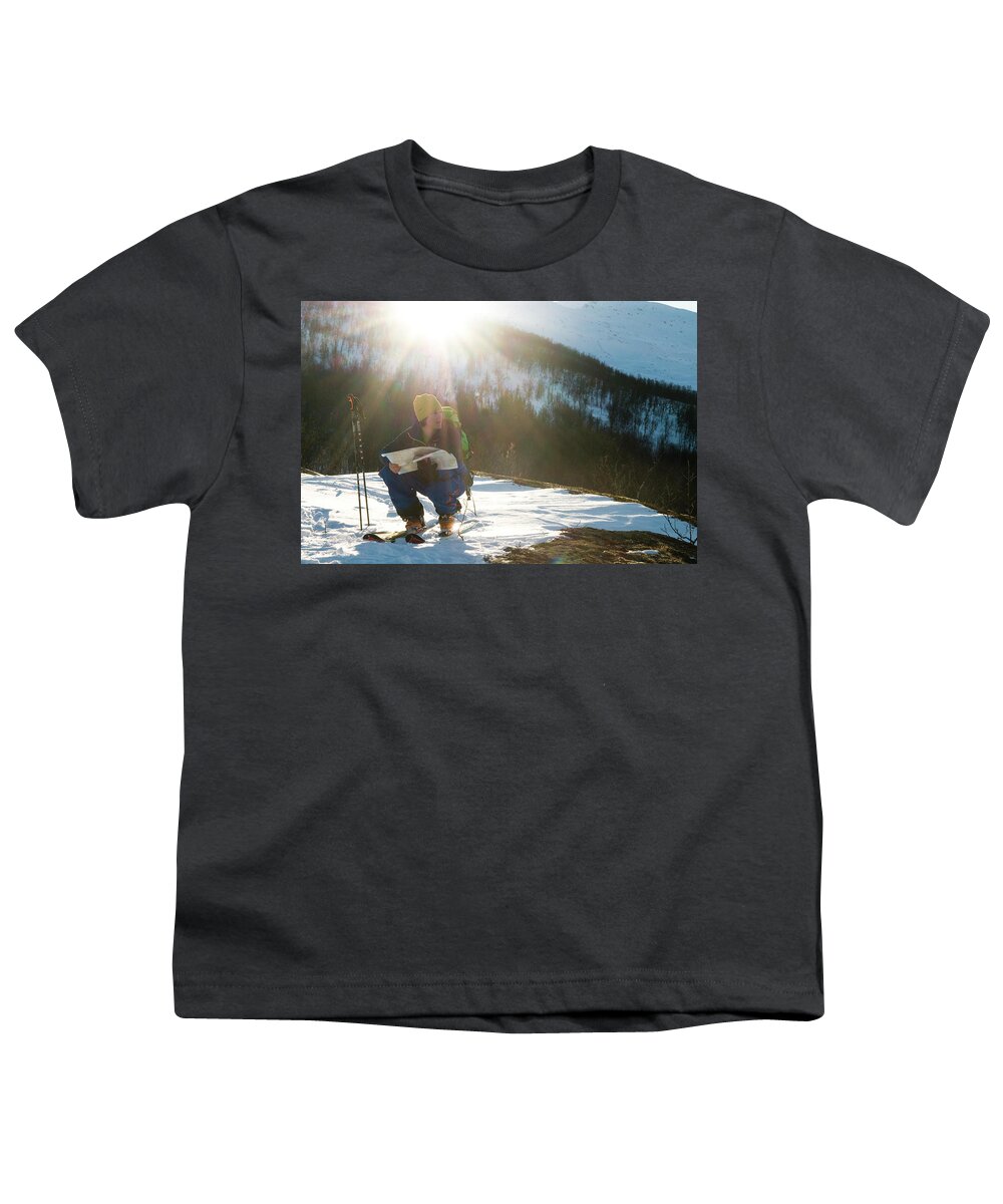 20s Youth T-Shirt featuring the photograph A Norwegian Skier Examines A Map by Kari Medig