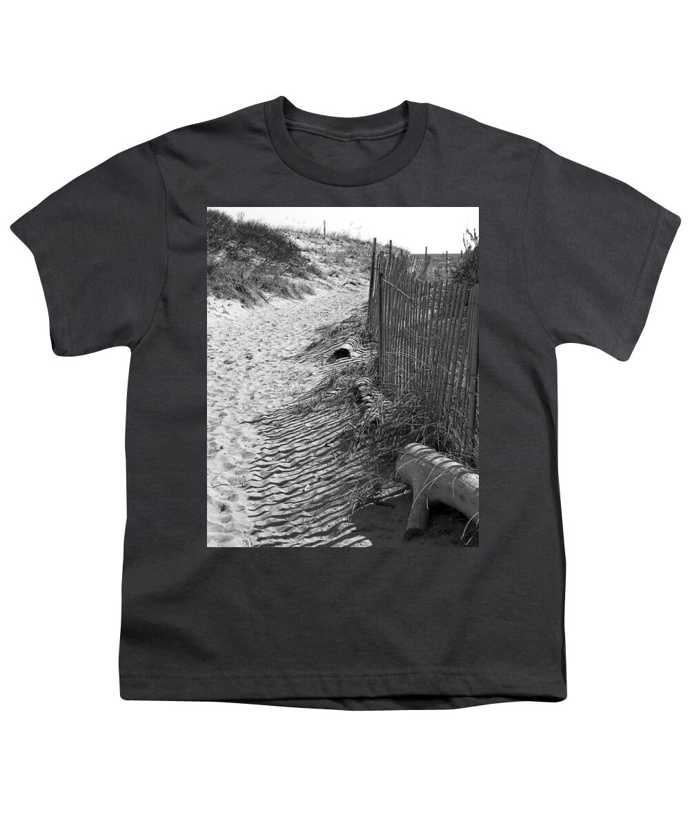 Beach Retaining Fence Youth T-Shirt featuring the photograph A Stroll In The Sand by Jeff Folger
