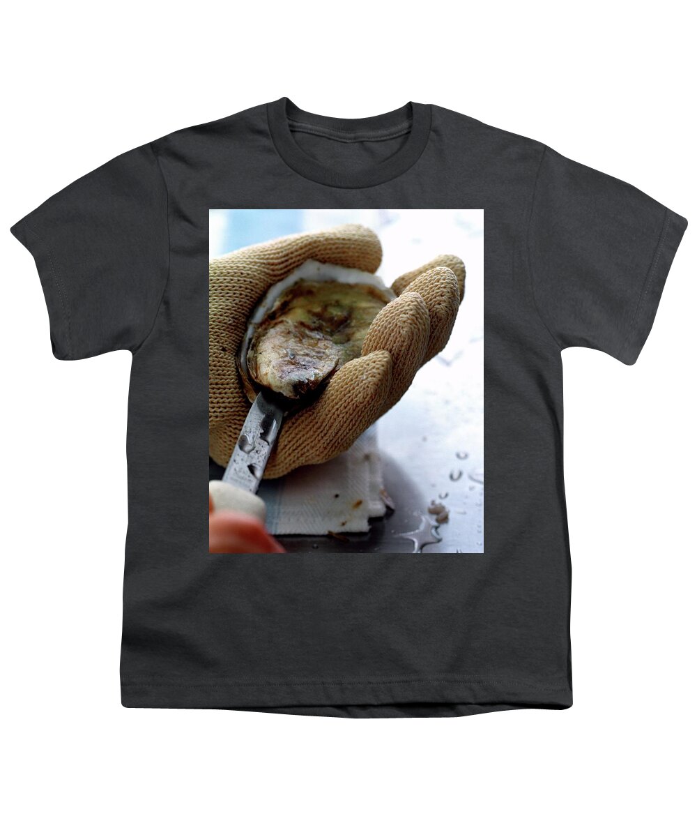 Cooking Youth T-Shirt featuring the photograph An Oytser Being Shucked by Romulo Yanes