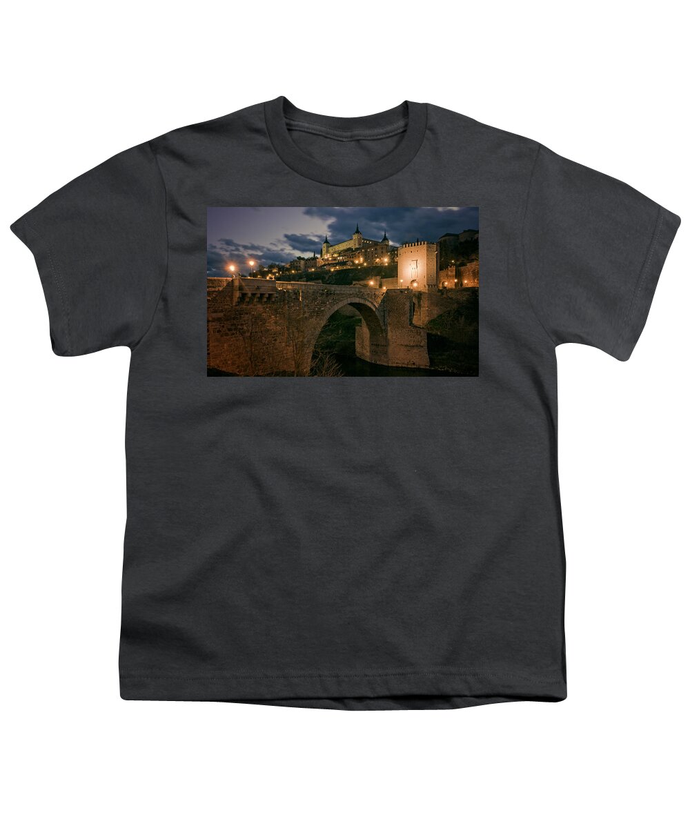 Joan Carroll Youth T-Shirt featuring the photograph Alcantara Bridge and Alcazar Toledo Night by Joan Carroll