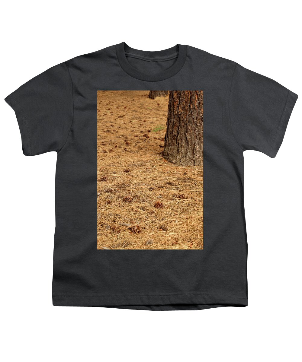 Bend Youth T-Shirt featuring the photograph Pine cones on forest floor near Lava Island by Steve Estvanik