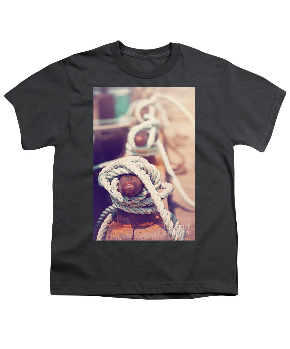 Sea Youth T-Shirt featuring the photograph Quayside cleats and tied ropes with boats moored in the backgrou by Jane Rix