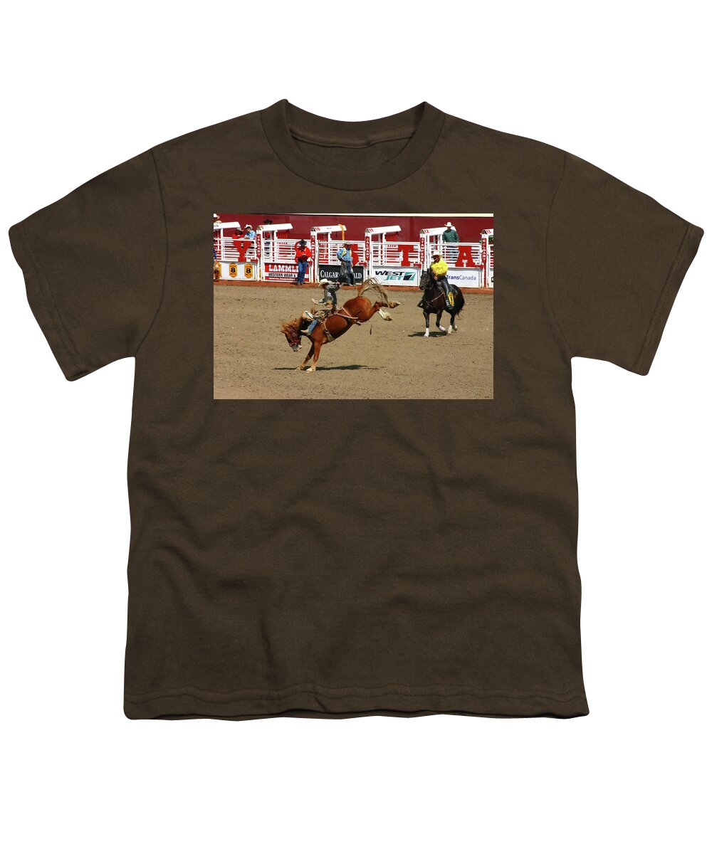 Canada Youth T-Shirt featuring the photograph Cowboy on bucking bronco #1 by Steve Estvanik