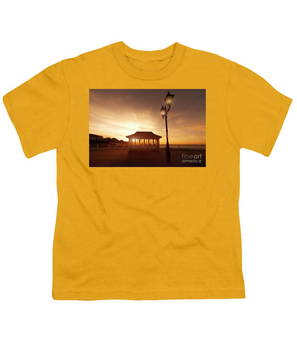 Norfolk Youth T-Shirt featuring the photograph Cromer pier in Norfolk England shelter at sunset by Simon Bratt