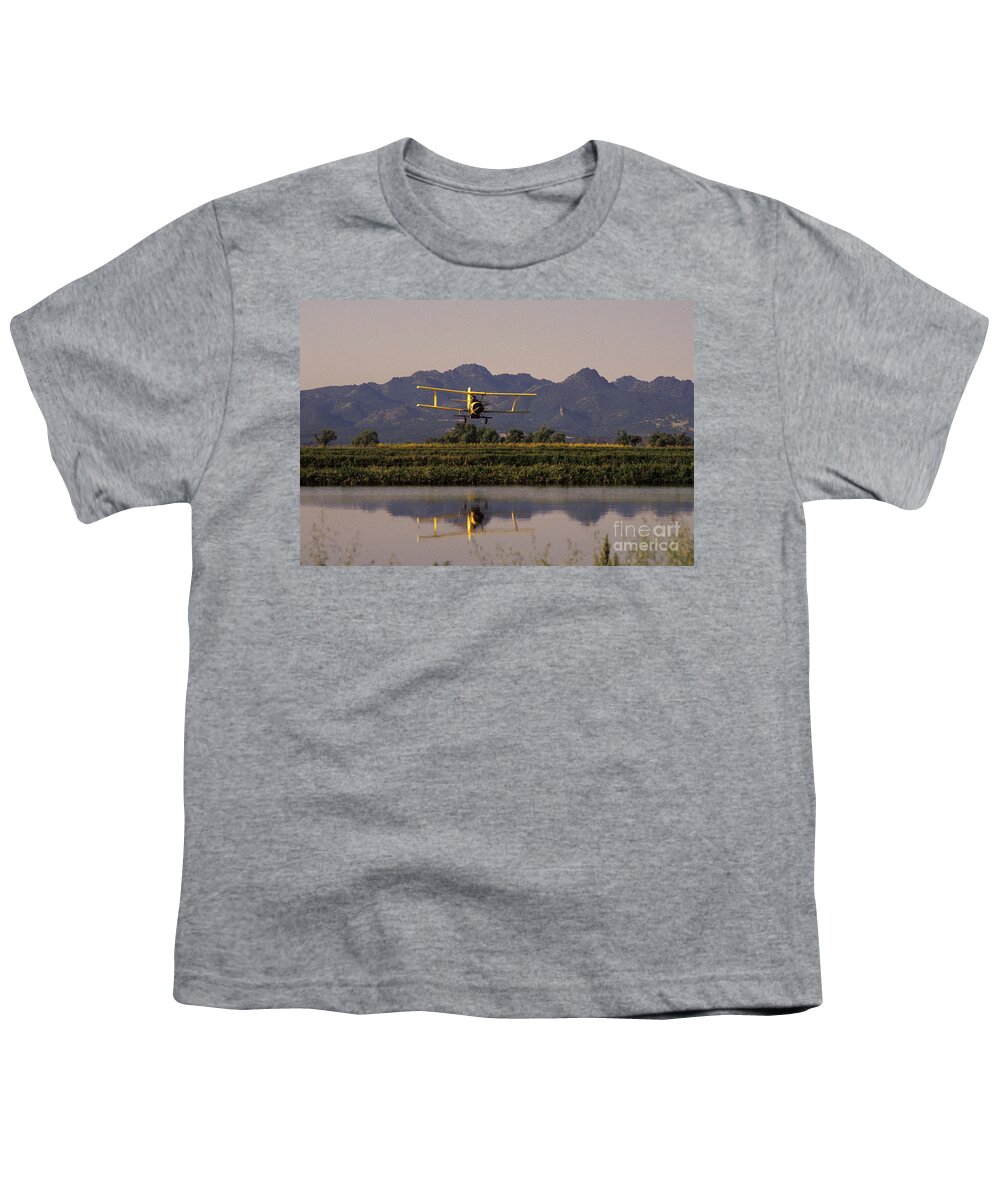 Agriculture Youth T-Shirt featuring the photograph Crop Duster Applying Seed To Rice Field by Ron Sanford