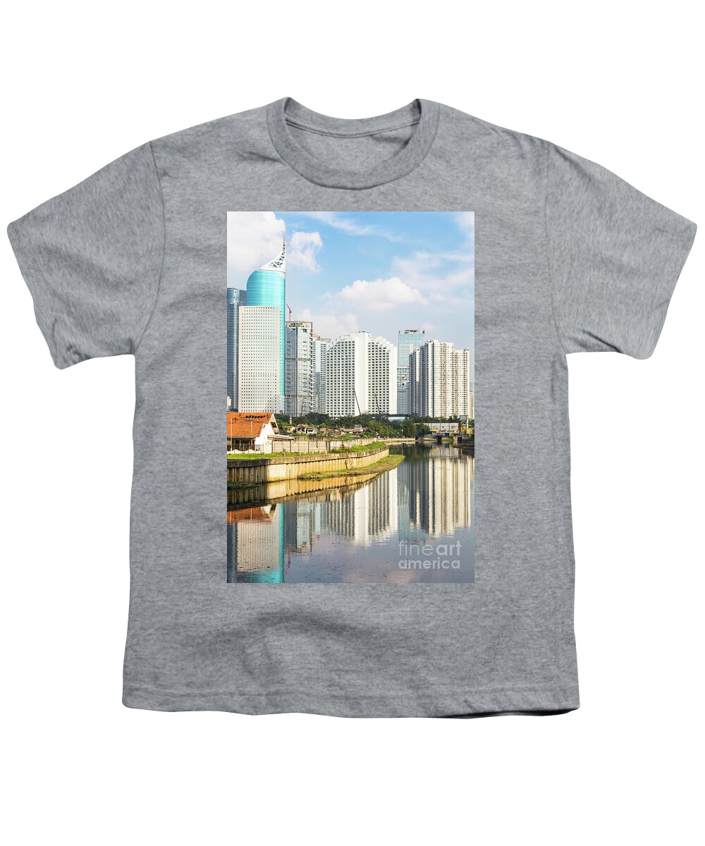 Capital Cities Youth T-Shirt featuring the photograph Tall buildings reflection in water in Jakarta business district #1 by Didier Marti