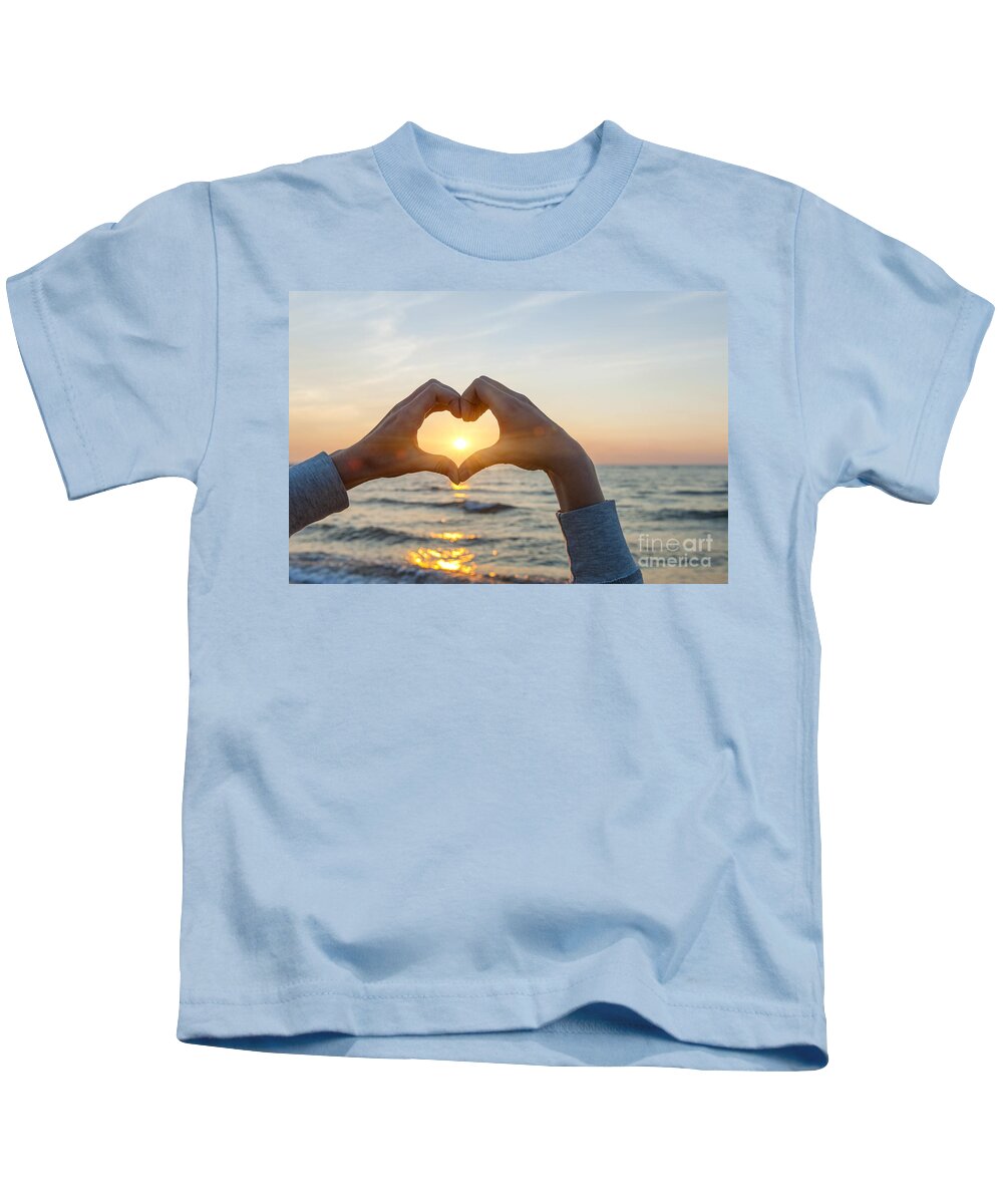 Heart Kids T-Shirt featuring the photograph Fingers heart framing ocean sunset by Elena Elisseeva
