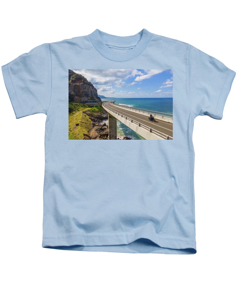 Bridge Kids T-Shirt featuring the photograph Sea Cliff Bridge and a Lone Biker by Andre Petrov