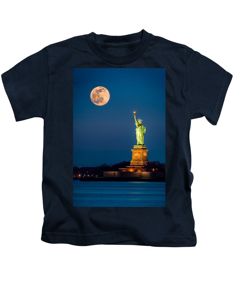 America Kids T-Shirt featuring the photograph Statue of Liberty and a rising supermoon in New York City by Mihai Andritoiu